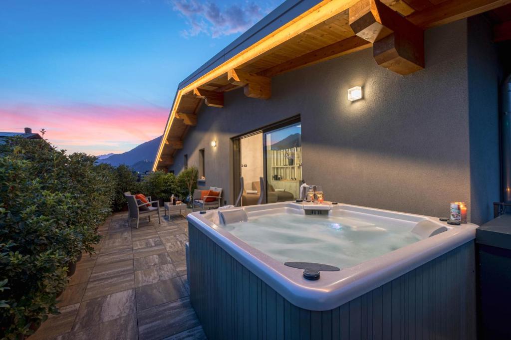 a bath tub sitting on the side of a house at Arbulé Agriturismo & Spa Valtellina in Poggiridenti