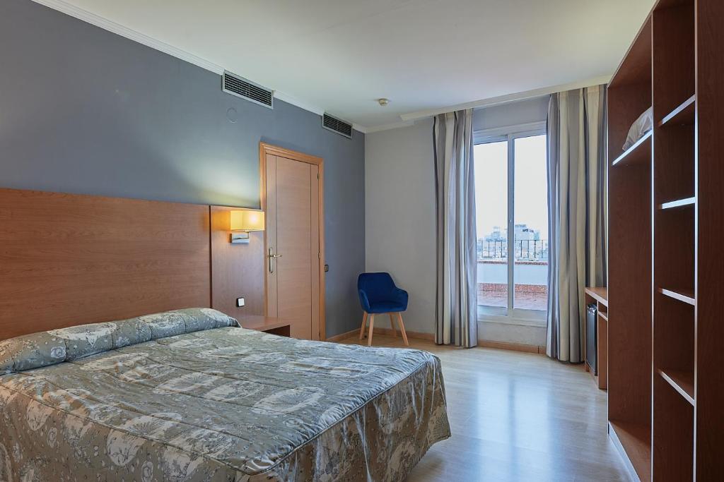 Posteľ alebo postele v izbe v ubytovaní Ramblas Hotel