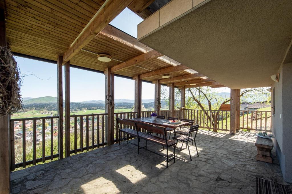 a patio with a table and chairs on a balcony at ZIDANICA KRŠTINC in Straža