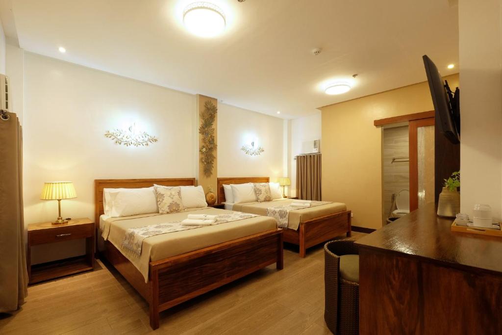 Postel nebo postele na pokoji v ubytování Jai-cob’s Suites
