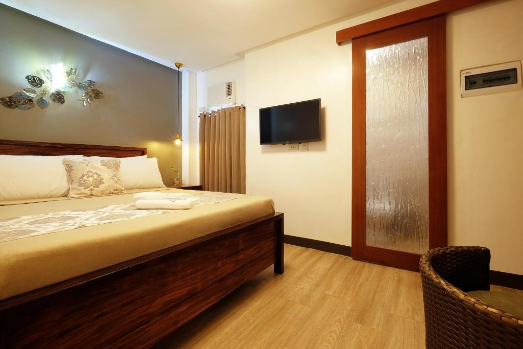 Postel nebo postele na pokoji v ubytování Jai-cob’s Suites