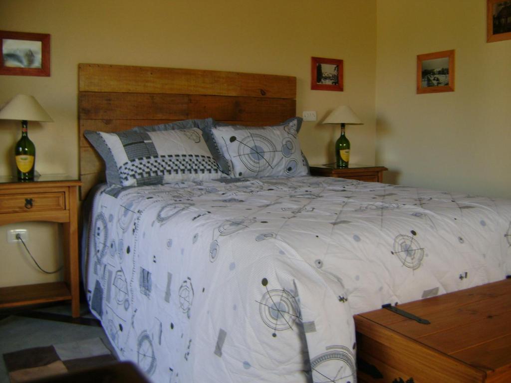 a bedroom with a large bed with a white comforter at Sobrado Nova Petropolis in Nova Petrópolis