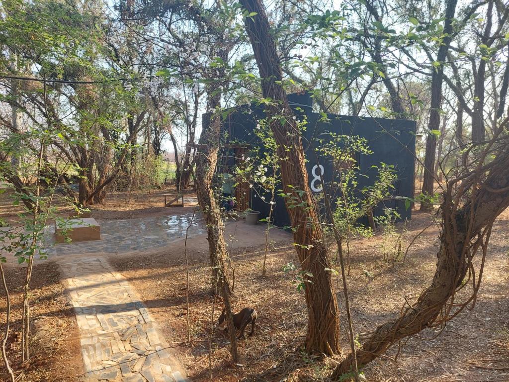 a tree with a sign on the side of it at Vulture's View 8 in Hartbeespoort