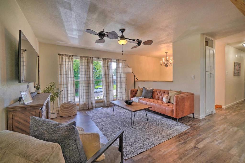 a living room with a couch and a table at Updated Knoxville Home with Media Room and Patio! in Knoxville