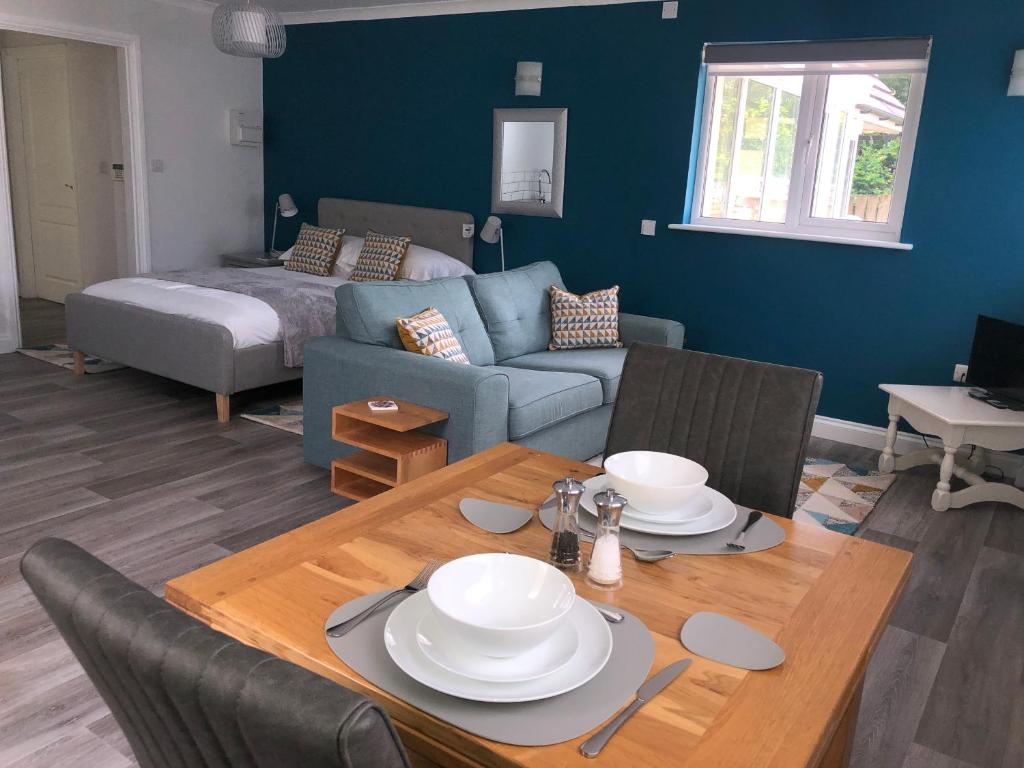 a living room with a table and a couch at Little Valley View in Otterham