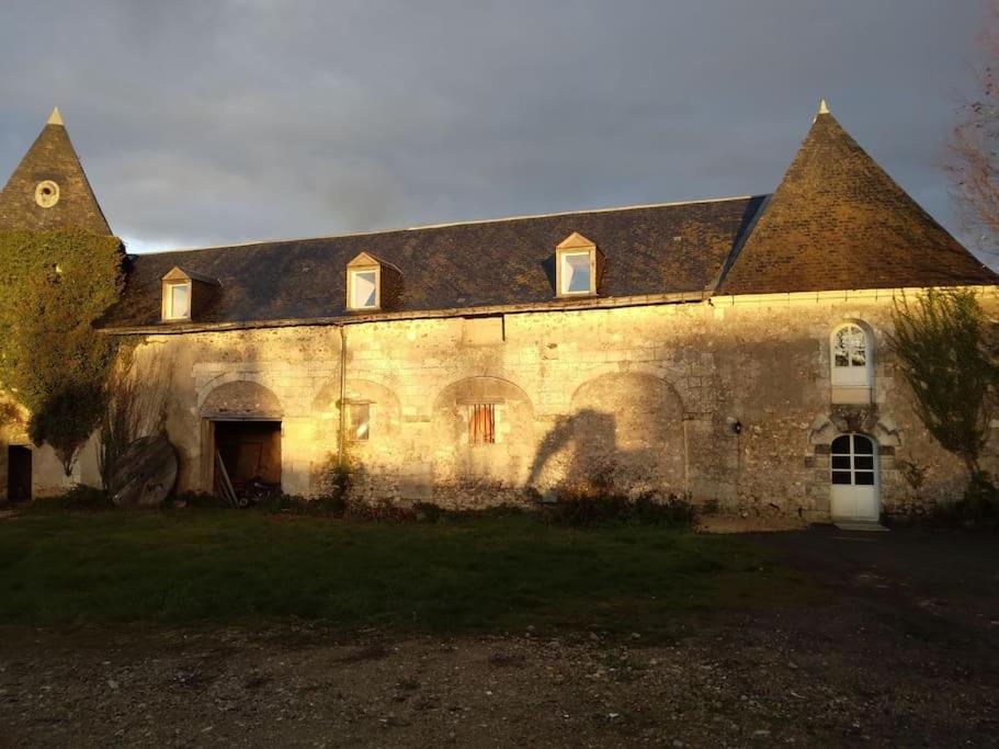 ein großes Steingebäude mit einem großen Dach in der Unterkunft La Chapelle in Chanceaux-sur-Choisille