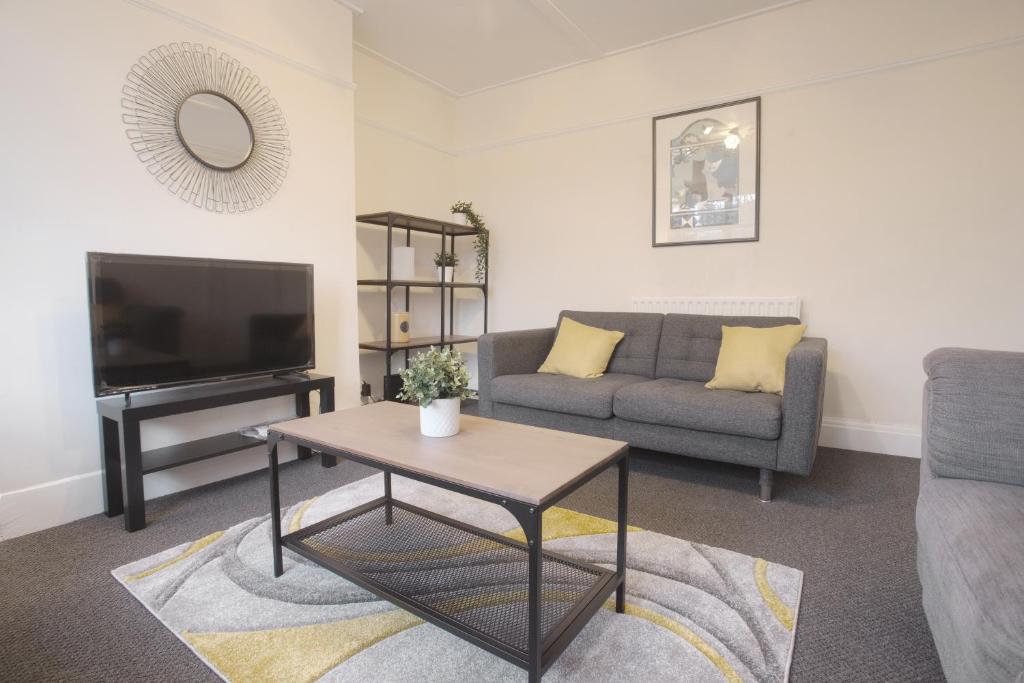 a living room with a couch and a table at Druids Hill in Bristol