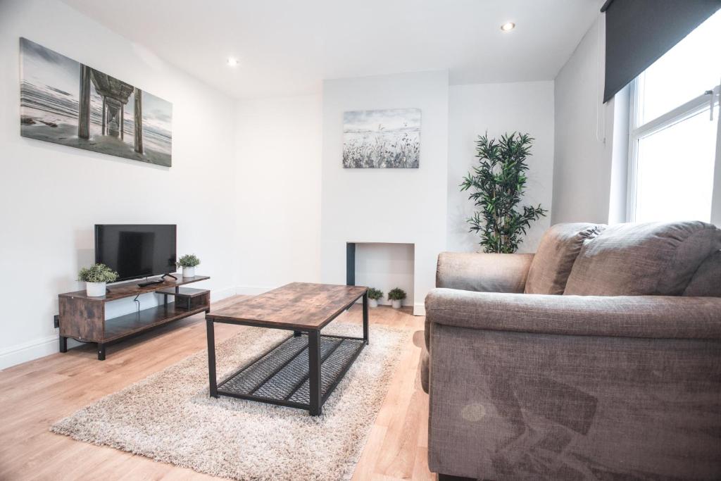 a living room with a couch and a table at 62b Mina Rd in Bristol