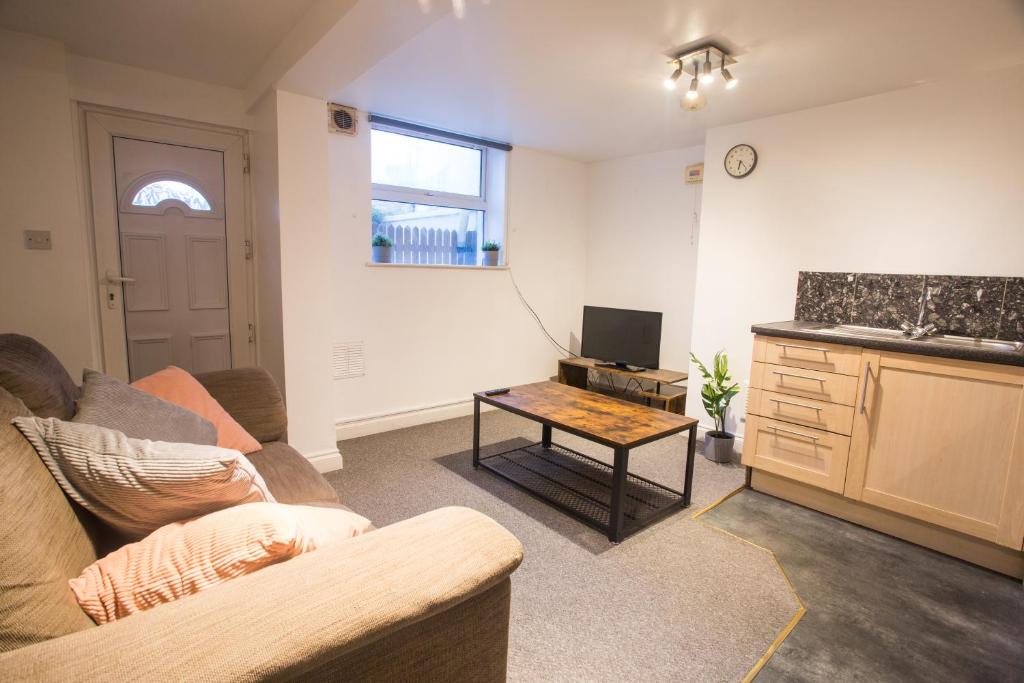 a living room with a couch and a table at Flat 1, 4 Warden Rd in Bristol