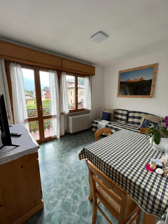 a living room with a table and a couch at Dolomitihouse AUNER in Fiera di Primiero