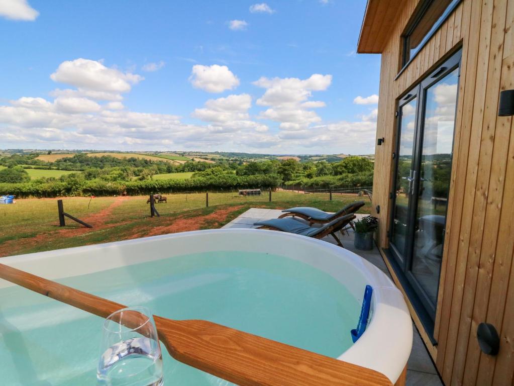 a bath tub with a view of a field at The Pennymoor in Tiverton