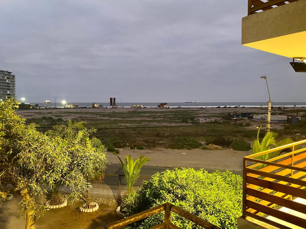 a view of the beach from the balcony of a building at Departamento Vistamar 4 puertas del pacifico in Arica