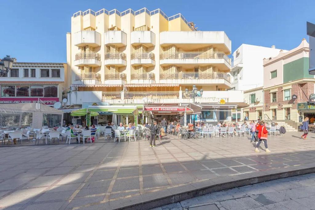 um grupo de pessoas andando em uma rua com um edifício em Puerta del Sol TRM only adults Aparts em Torremolinos