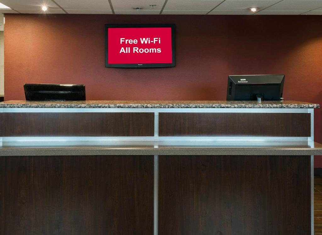 a sign that reads free wi fi all rooms at Red Roof Inn & Suites Omaha - Council Bluffs in Council Bluffs