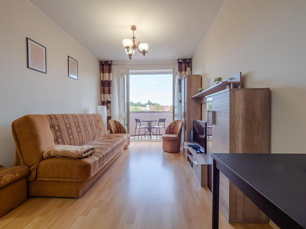 a living room with a couch and a television at Mieszkanie Centrum in Iława