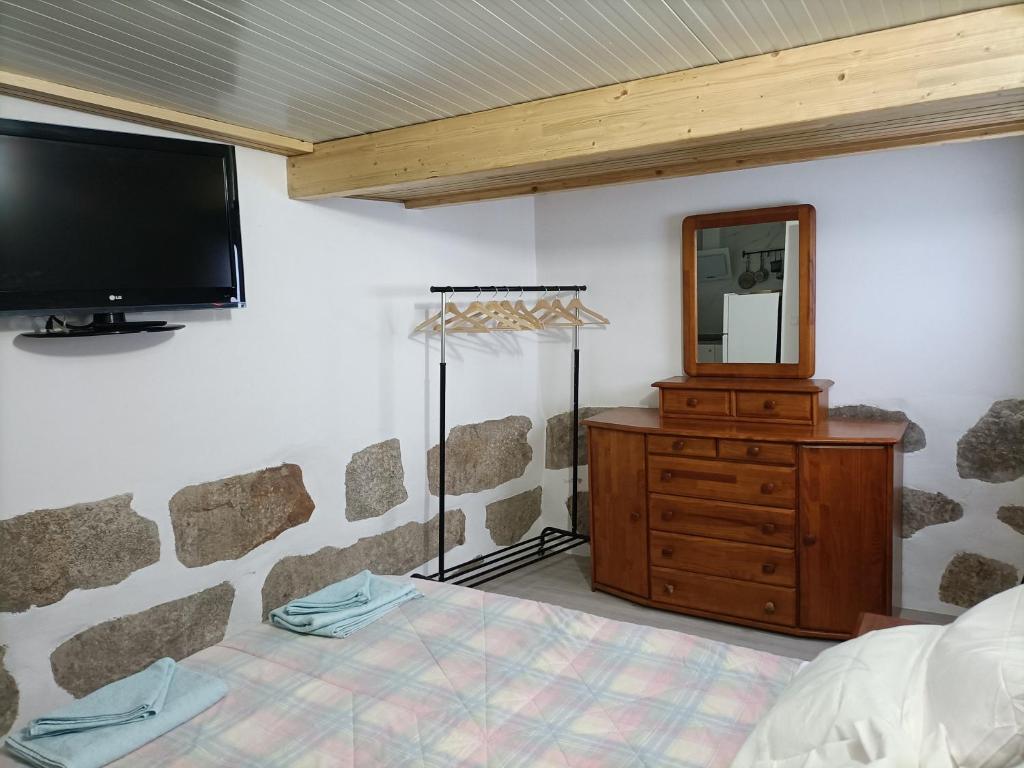 a bedroom with a bed and a mirror and a tv at CIH - Constituição Invicta Home in Porto