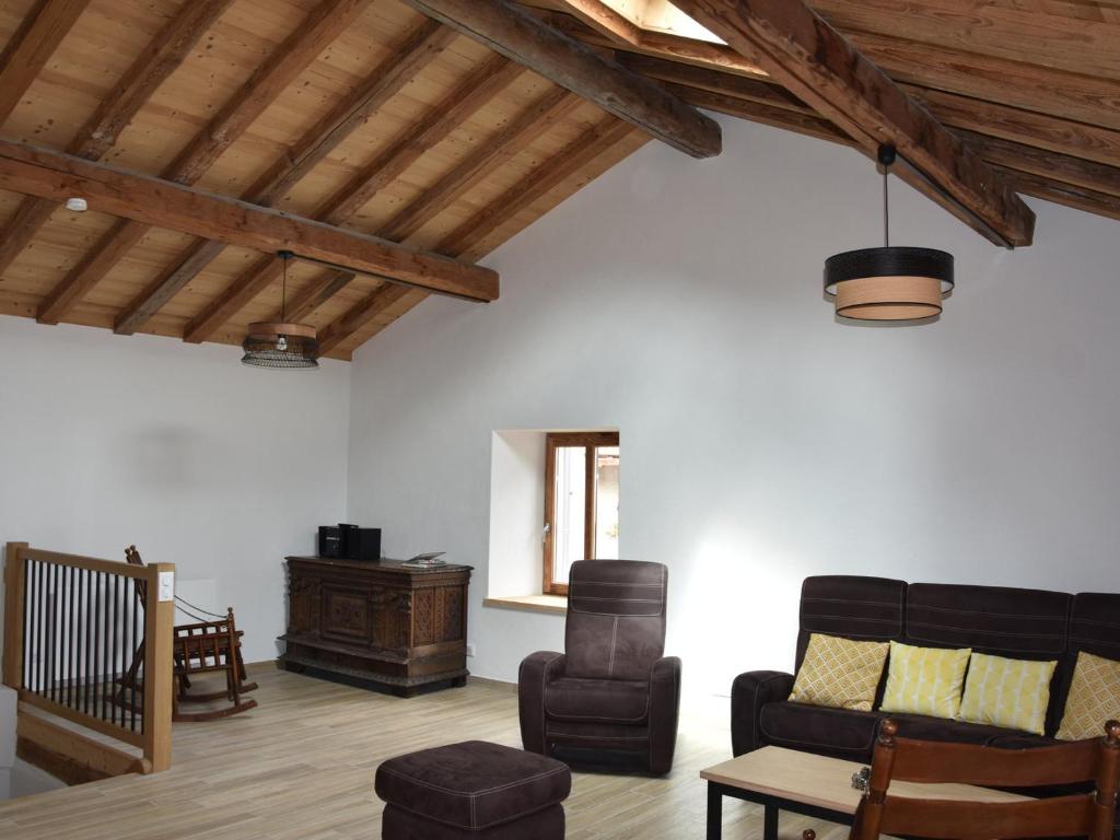a living room with a couch and a chair at Chalet Pralognan-la-Vanoise, 5 pièces, 10 personnes - FR-1-464-203 in Pralognan-la-Vanoise