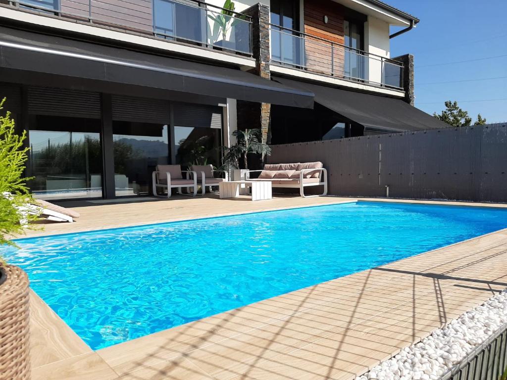 a swimming pool in front of a house at Ikasmendi in Rentería