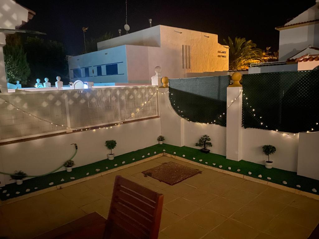 a white fence with lights and plants on it at SUNSET Home ISLANTILLA in Islantilla