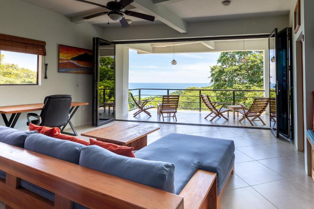 a living room with a couch and a balcony at Casa Paraíso - 3rd Floor in San Juan del Sur