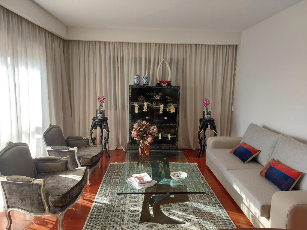 a living room with a couch and chairs and a table at Praia Azul Boutique Apartment in Vila do Conde