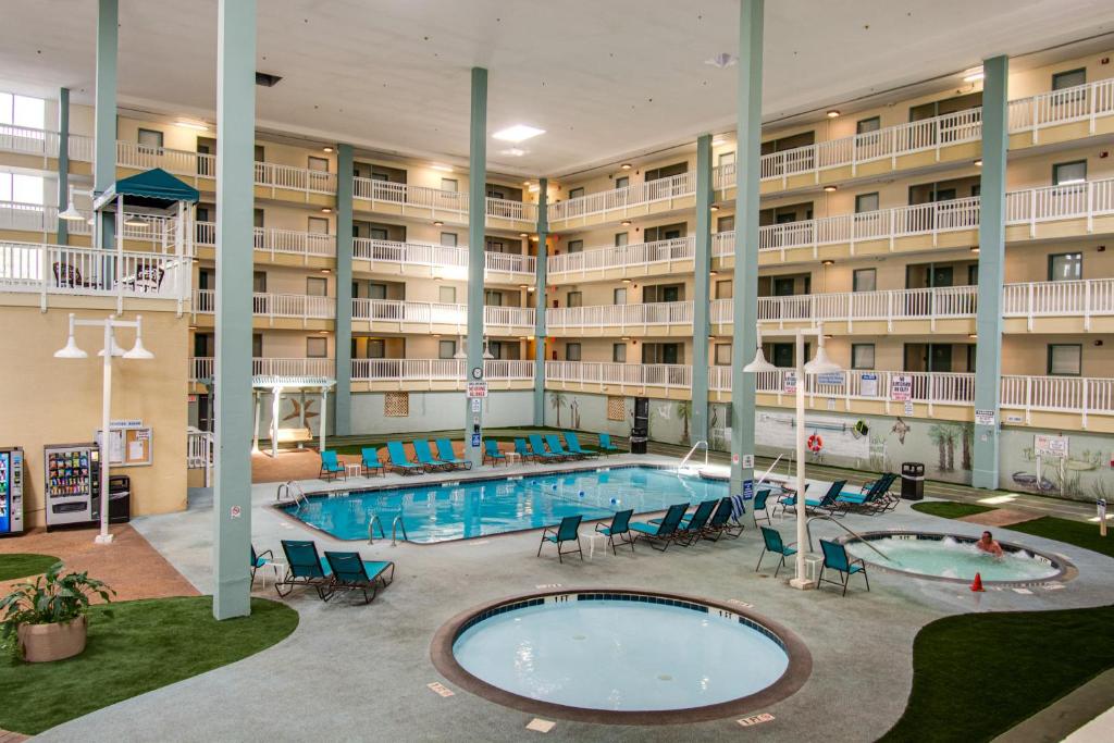 a large hotel with a swimming pool in front of a building at Beach side condo at Hilton Head Resort Villas in Hilton Head Island