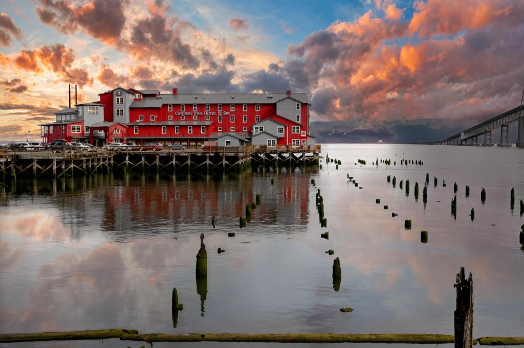 a red building on a dock in the water at Cannery Pier Hotel & Spa in Astoria, Oregon