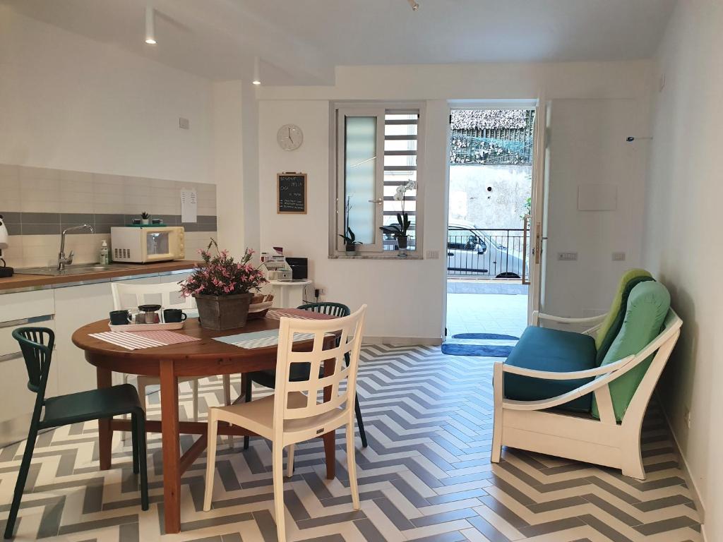 a kitchen and dining room with a table and chairs at La Casa di Mina in Monte di Procida