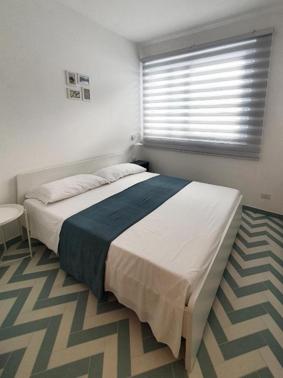 Łóżko lub łóżka w pokoju w obiekcie La Casa di Mina