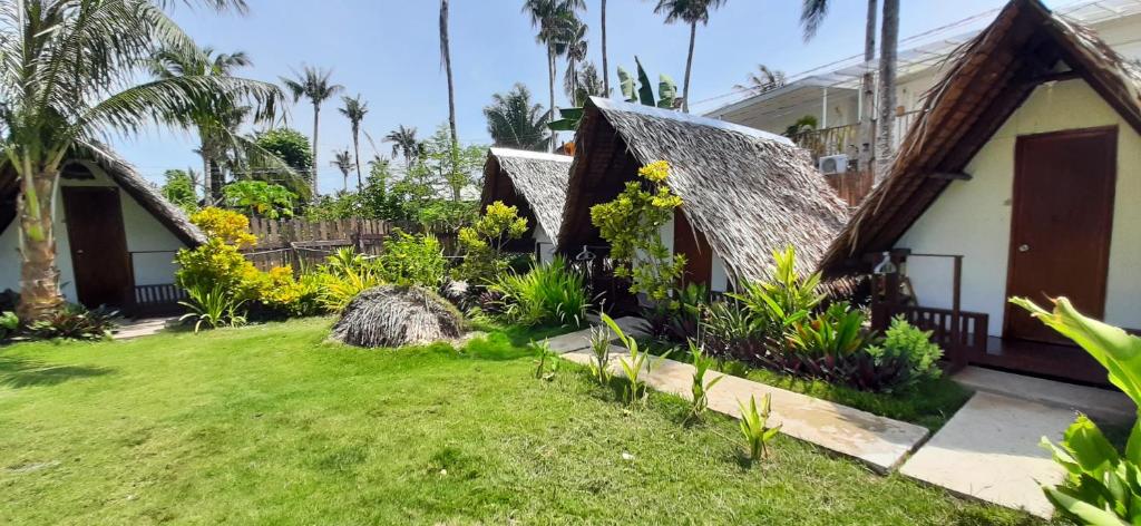 a house with a garden in front of it at Dream Catcher Nipas Siargao in General Luna