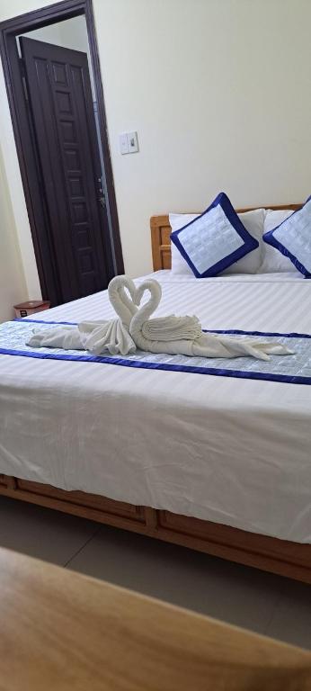 Postel nebo postele na pokoji v ubytování Blue Beach Homestay