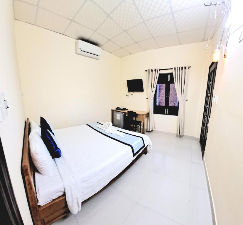 Postel nebo postele na pokoji v ubytování Blue Beach Homestay