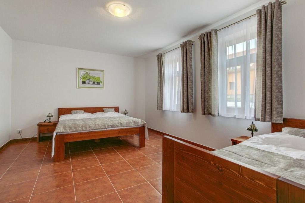 Postel nebo postele na pokoji v ubytování Apartmány U Anděla