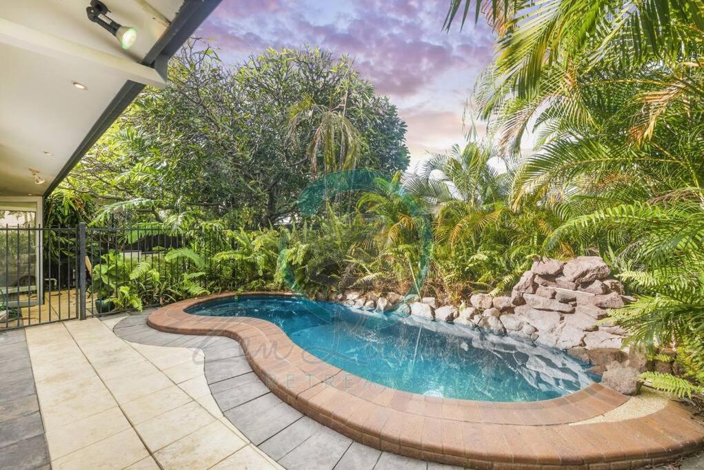 an image of a swimming pool in a garden at ZEN TREETOPS - Boutique 2-BR Apt w/ Private Pool in Larrakeyah