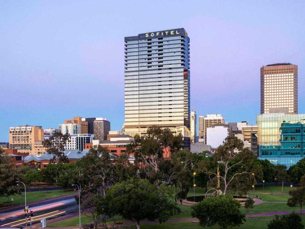 une ligne d'horizon avec un grand bâtiment au premier plan dans l'établissement Sofitel Adelaide, à Adélaïde