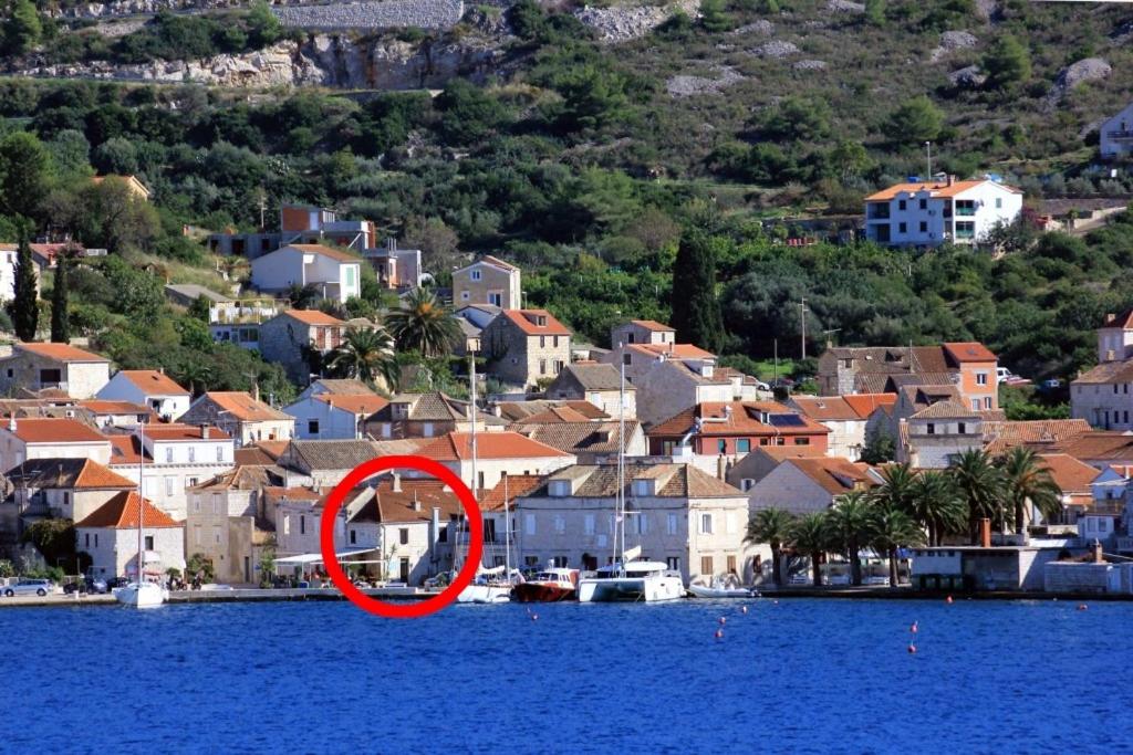 a red circle sitting on the water in front of a city at Apartments by the sea Vis - 8875 in Vis