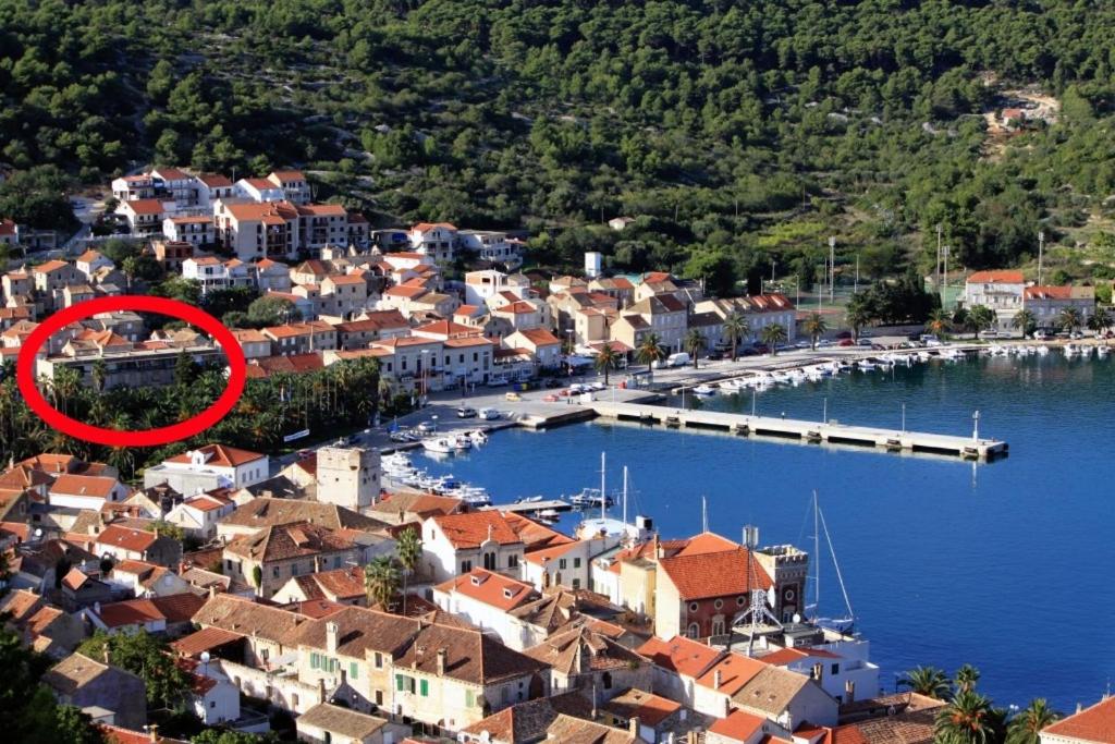 a small town with a marina with a red circle at Apartments by the sea Vis - 8906 in Vis