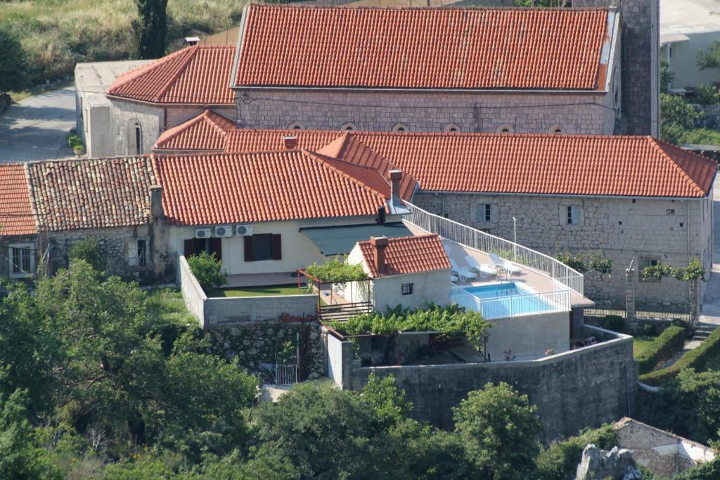 an aerial view of a house with red roofs at Holiday house with a swimming pool Dubravka, Dubrovnik - 9101 in Gruda