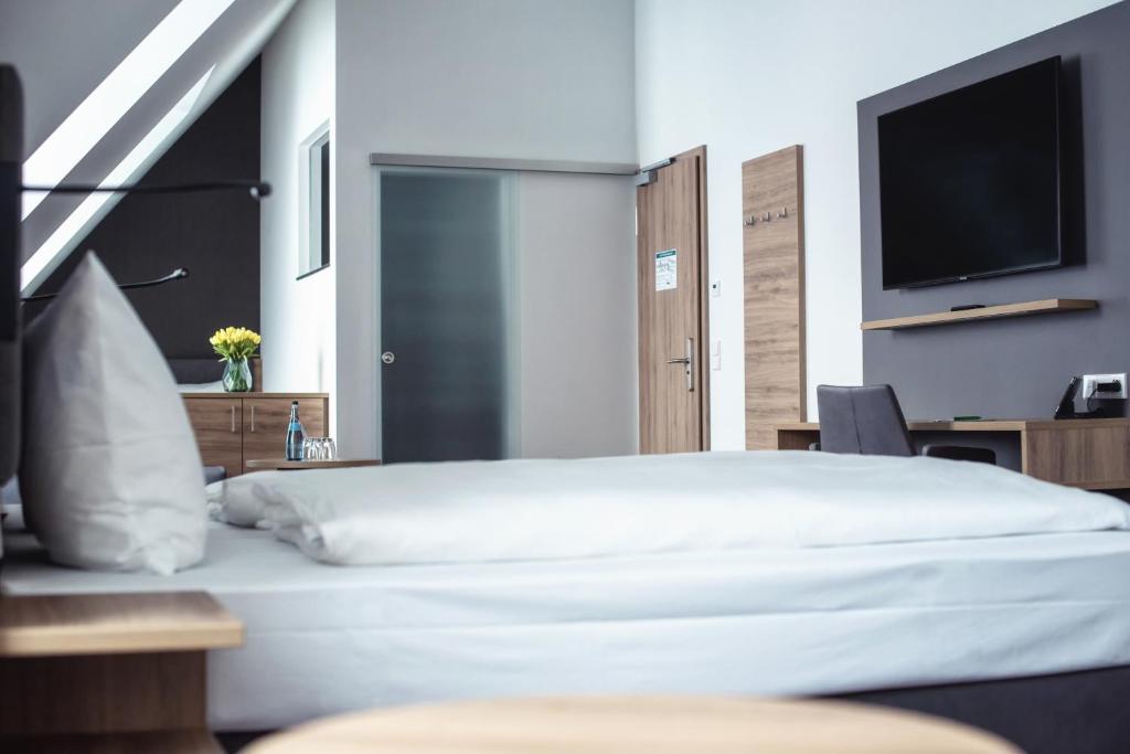 Postel nebo postele na pokoji v ubytování Hotel Kupferzell