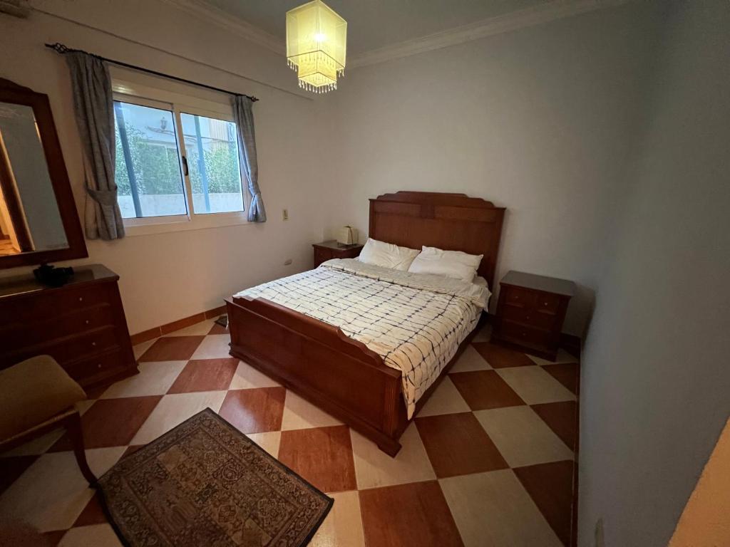 a bedroom with a bed and a checkered floor at Morning Star Guesthouse in Sharm El Sheikh