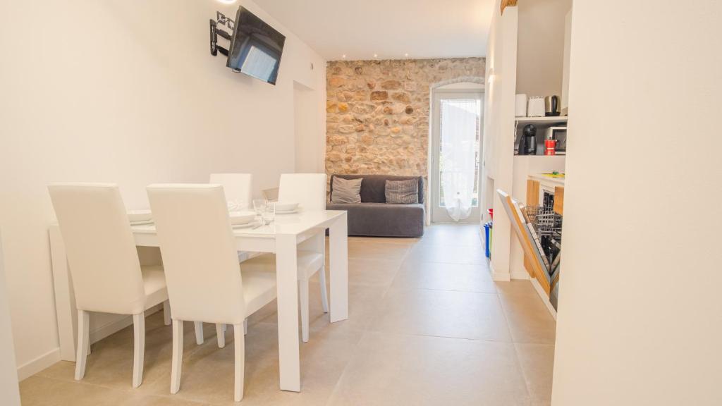 a kitchen and dining room with a white table and chairs at Elide Home Sweet Home - Italian Homing in Padenghe sul Garda