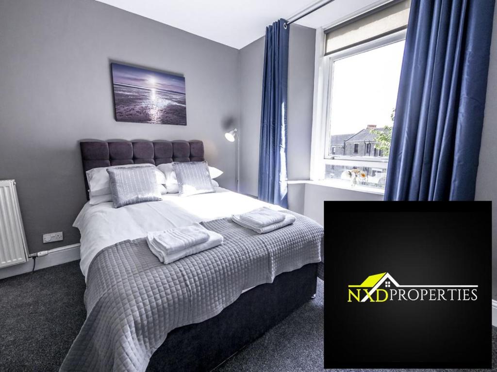 a bedroom with a large bed and a window at New Superhost Listing: Bright flat nr. University in Dundee