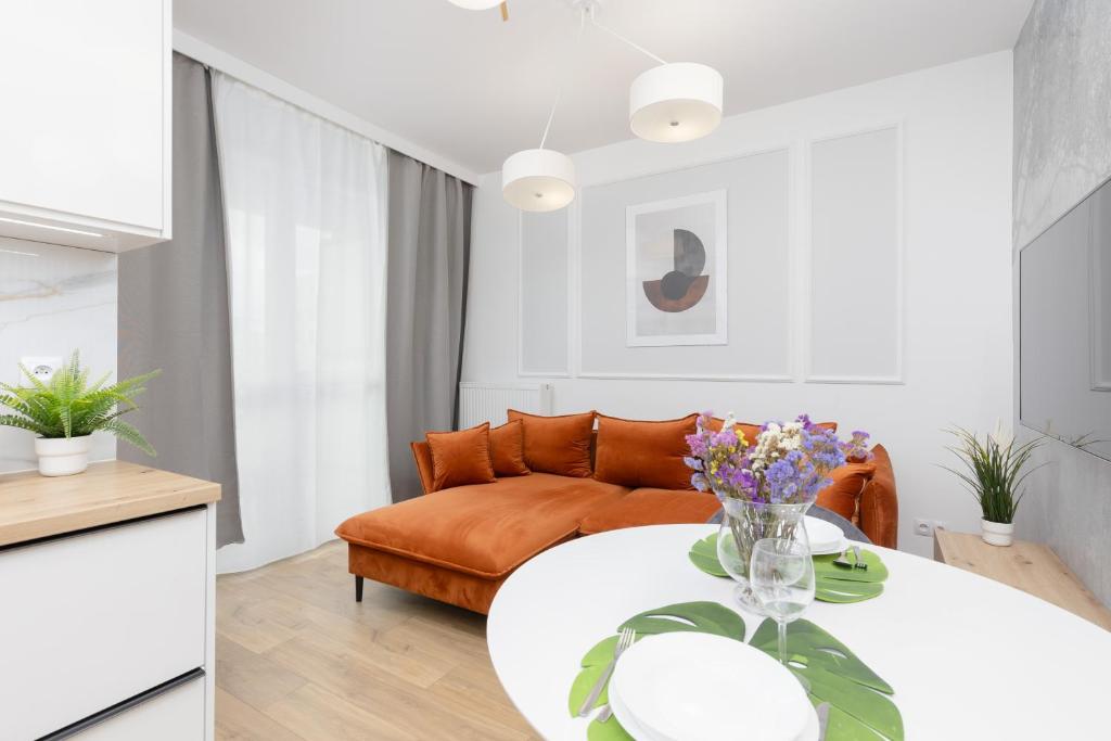 a living room with a couch and a table at Golden Apartments Ursynów by Renters in Warsaw