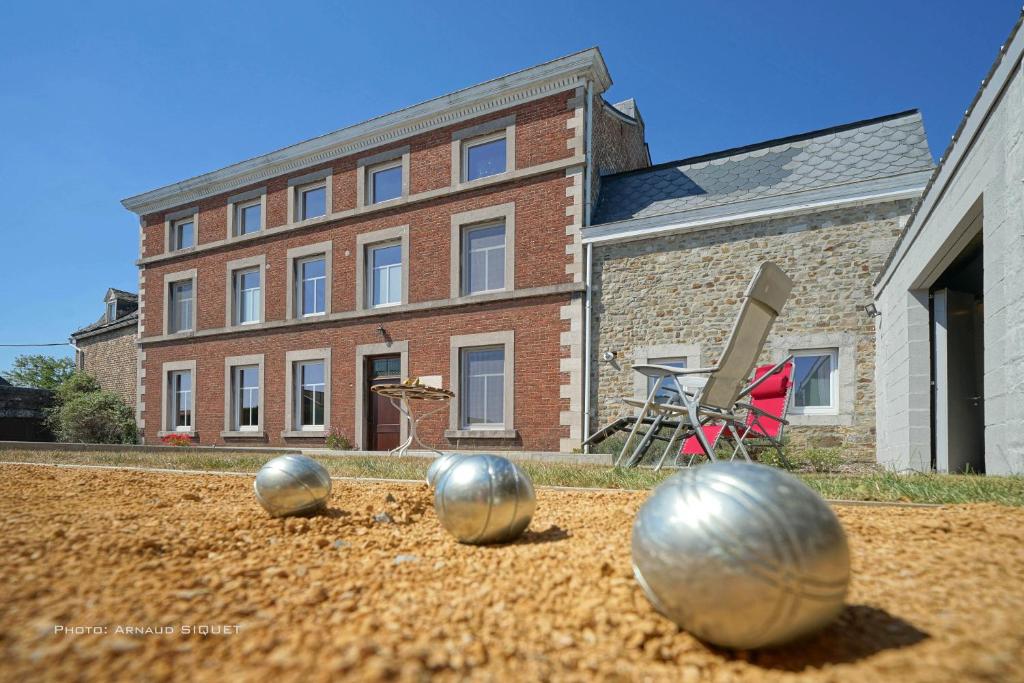a house with two silver balls in the dirt at Gîtes Chez Oncle Nicolas in Soumagne