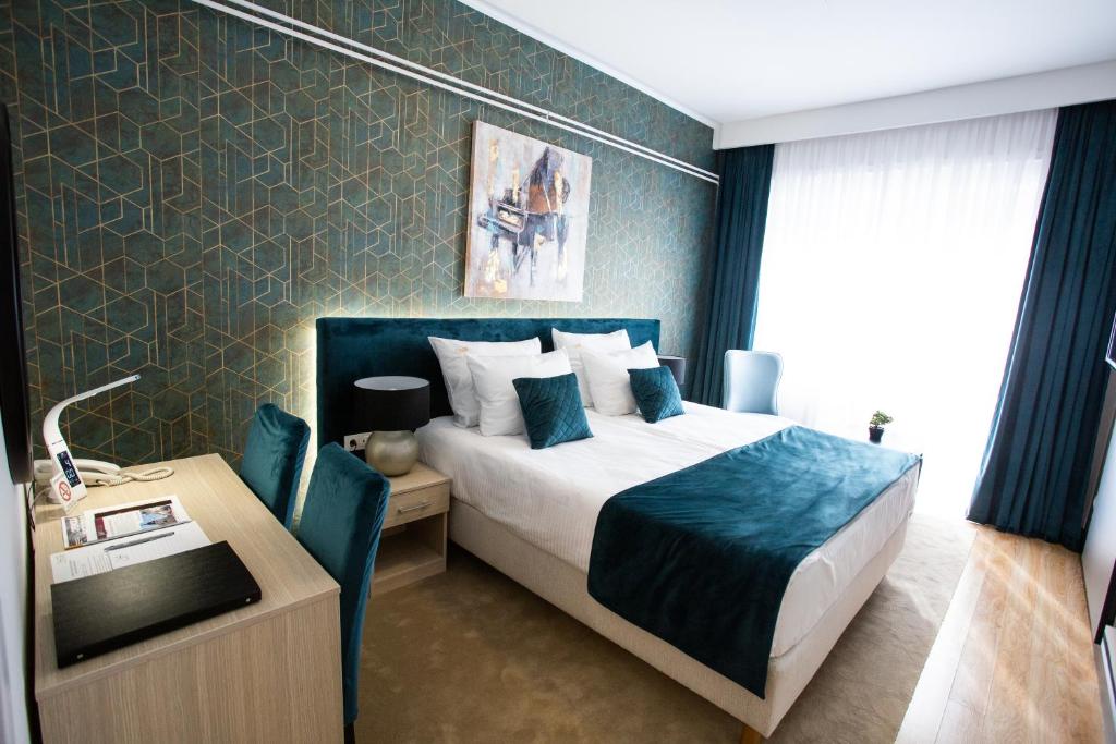 Postel nebo postele na pokoji v ubytování Hotel Srem