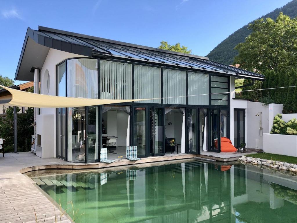 uma vista exterior de uma casa com piscina em Das Poolhaus em Rottau