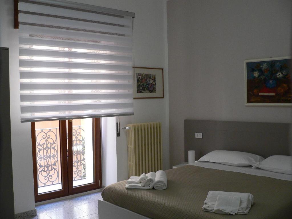 Postel nebo postele na pokoji v ubytování Locanda Pezzolla