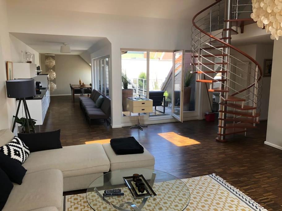 a living room with a white couch and a spiral staircase at Ruhige Dachwohnung mit Terrasse Berlin MITTE - Spacious modern rooftop loft in Berlin MITTE in Berlin