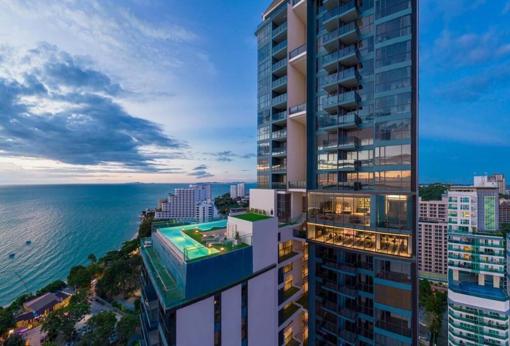 an aerial view of a tall building overlooking the ocean at Unique 1-BR w/Seaview Balcony and Onsen in Pattaya in Pattaya South