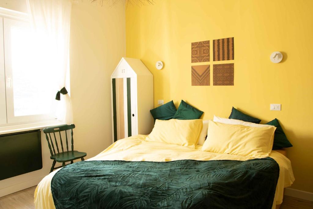sypialnia z łóżkiem z krzesłem i oknem w obiekcie VITEDIMARE APARTMENT SOLE - SUN w mieście Muggia